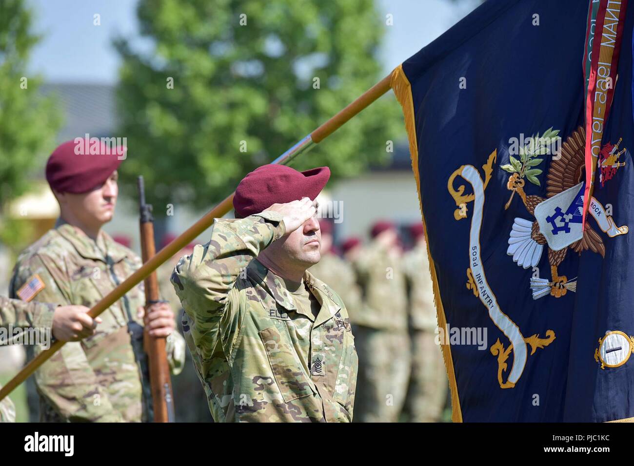 U.S. Army Sgt. Maj. Kevin A. Mclellan, Paratrooper assigned to the 1st Battalion, 503rd Infantry Regiment, 173rd Airborne Brigade, salutes and present colors during the change of responsibility ceremony at Caserma Ederle in Vicenza, Italy, July 19, 2018. The 173rd Airborne Brigade is the U.S. Army Contingency Response Force in Europe, capable of projecting ready forces anywhere in the U.S. European, Africa or Central Commands' areas of responsibility. Stock Photo
