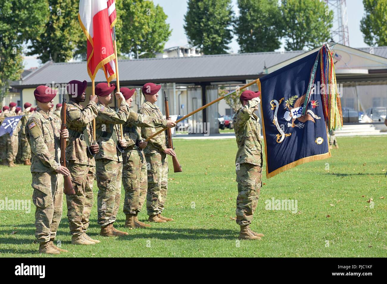U.S. Army Sgt. Maj. Kevin A. Mclellan, Paratrooper assigned to the 1st Battalion, 503rd Infantry Regiment, 173rd Airborne Brigade, salutes and present colors during the change of responsibility ceremony at Caserma Ederle in Vicenza, Italy, July 19, 2018. The 173rd Airborne Brigade is the U.S. Army Contingency Response Force in Europe, capable of projecting ready forces anywhere in the U.S. European, Africa or Central Commands' areas of responsibility. Stock Photo