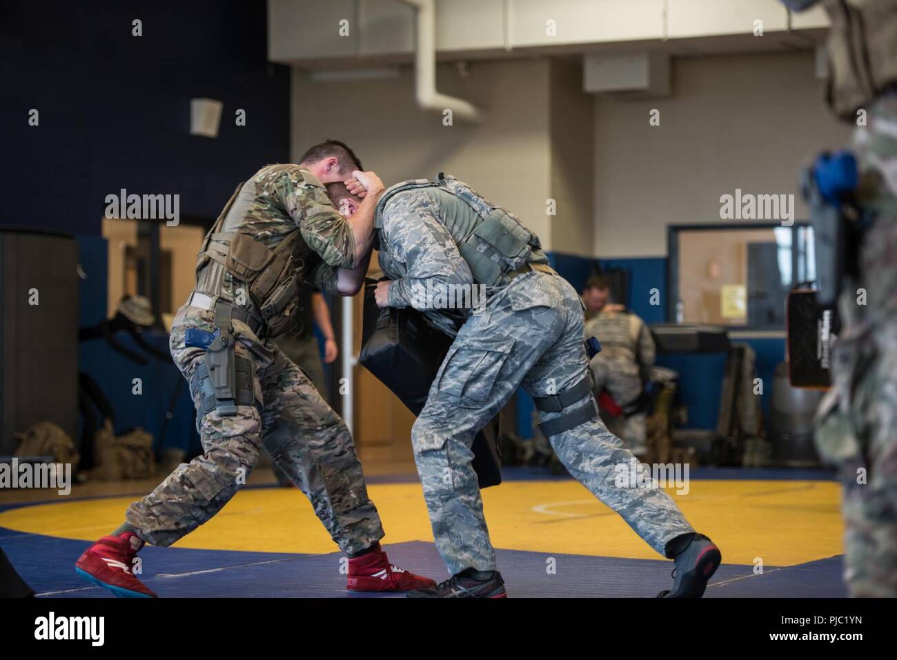 A security forces specialist (left) from the 193rd Special Operations Security Forces Squadron, Pennsylvania Air National Guard, defends himself during a single-assailant drill July 13, 2018 at the Middletown High School in Middletown, Pennsylvania. The 193rd SOSFS Airmen utilized the four defensive concepts (mobility, winning the angle, distance management, and transition) they learned from the previous two days to defend themselves in a hostile situation. Stock Photo