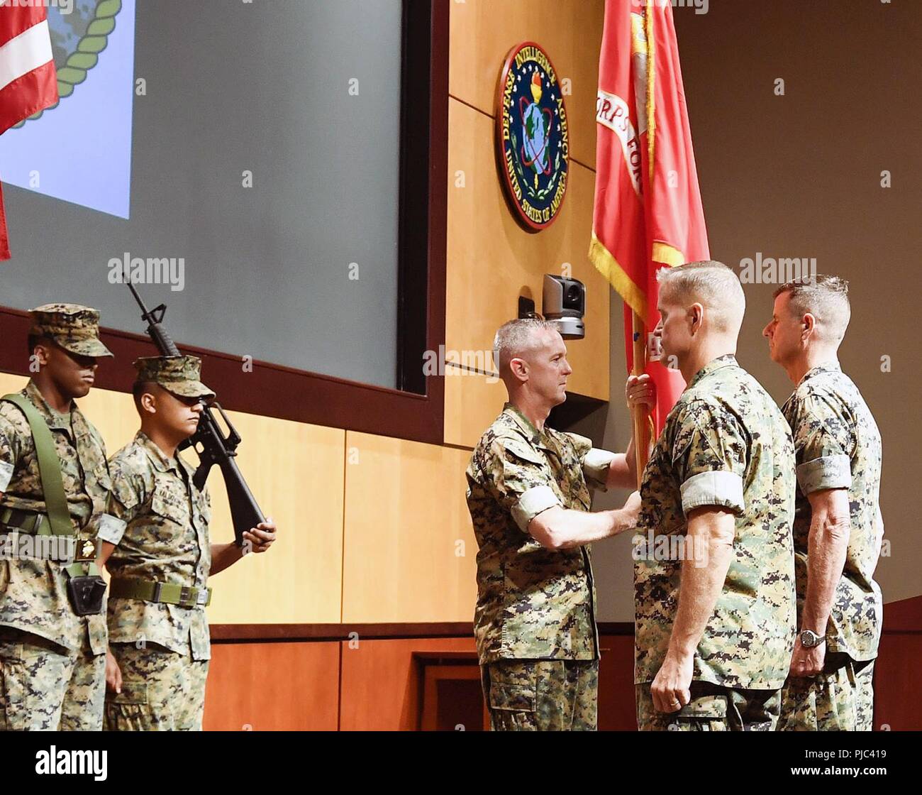 Sergeant Major William T. Thurber, U.S. Marine Corps Forces Central Command sergeant major, presents the MARCENT battle colors to Lt. Gen. Dave “Smoke” Beydler during a change of command ceremony at the Vince Tolbert Building at MacDill Air Force Base, July 11. Beydler, who has served as the MARCENT commander since Oct. 27, 2015, will pass the battle colors to Lt. Gen. Carl E. Mundy, III, representing the exchange of command. Stock Photo