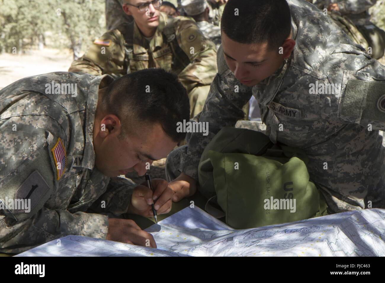 FORT HUNTER LIGGETT-- U.S. Army Sgt. Manuel Pelago and Spc. Rosario Manzanedo of the 348th Transportation Company sharpen their map reading skills during the 91st Training Division's Combat Support Training Exercise (CSTX 91-18-01) on July 11, 2018 in Ft. Hunter Liggett, California. The CSTX 91-18-01 ensures America’s Army Reserve units are trained to deploy bringing capable, combat-ready, and lethal firepower in support of the Army and our joint partners anywhere in the world. Stock Photo