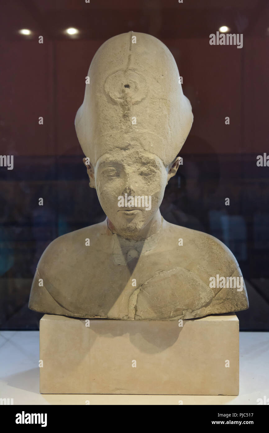 Limestone bust of Pharaoh Akhenaten in the Amarna style on display in the Louvre Museum in Paris, France. Stock Photo