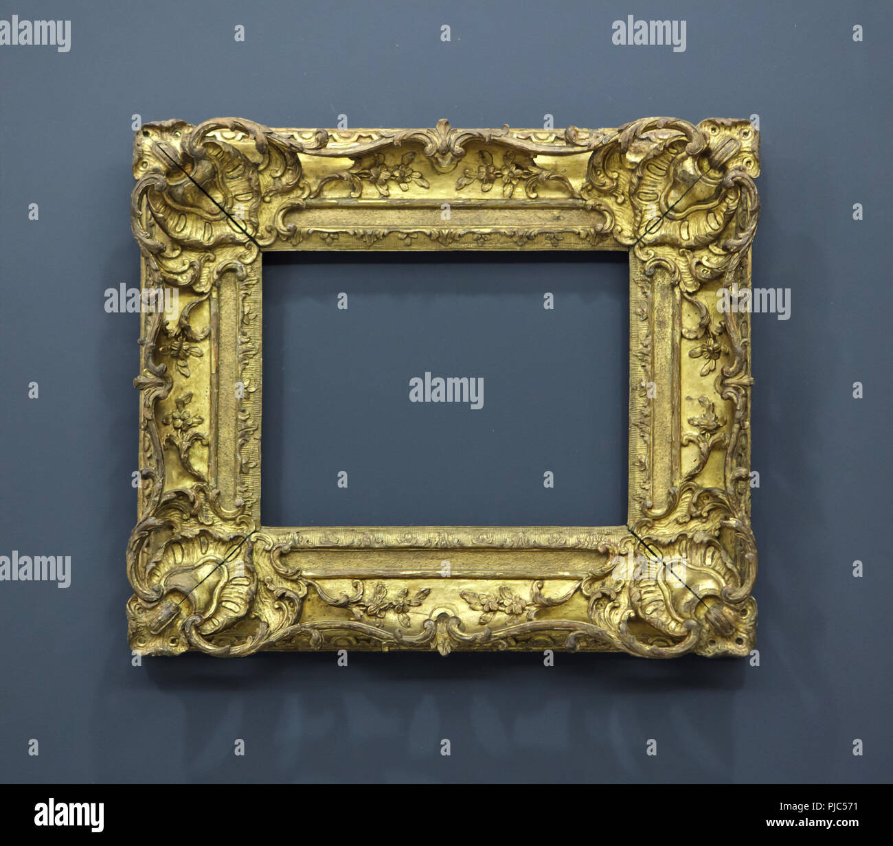 Empty gilded frame on display in the Louvre Museum in Paris, France. Stock Photo