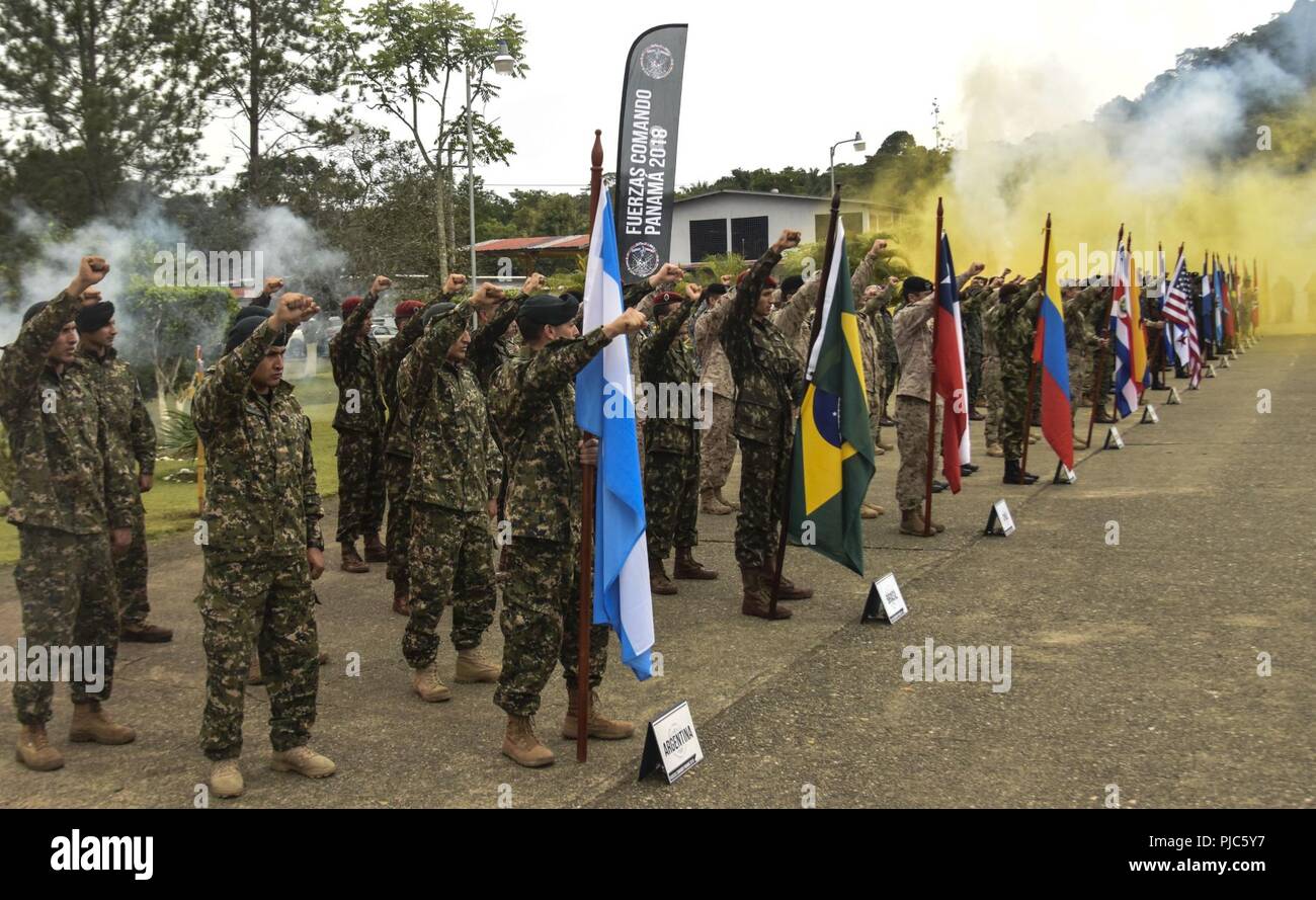 Participants of Fuerzas Comandos raise their fist and recite the Comando creed during the Fuerzas Comando opening ceremony, July 16, 2018, at the Instituto Superior Policial, Panama. Fuerzas Comando is an annual multinational special operations forces skills competition sponsored by U.S. Southern Command and hosted this year by the Ministry of Public Security, Panama. Through friendly competition, this exercise promotes interoperability, military-to-military relationships, increases training knowledge, and improves regional security. Stock Photo