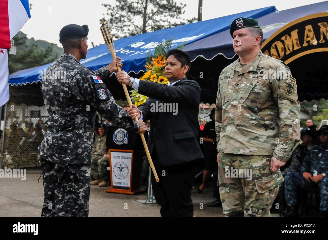 Minister Alexis Bethancourt Yau, minister of public security, and U.S. Army Col. Brian Greata, deputy commanding officer of Special Operations Command South accept the torch from the Panamanian Comandos to commence Fuerzas Comando during an opening ceremony, July 16, 2018, at the Instituto Superior Policial, Panama. Fuerzas Comando is an annual multinational special operations forces skills competition sponsored by U.S. Southern Command and hosted this year by the Ministry of Public Security, Panama. Through friendly competition, this exercise promotes interoperability, military-to-military re Stock Photo