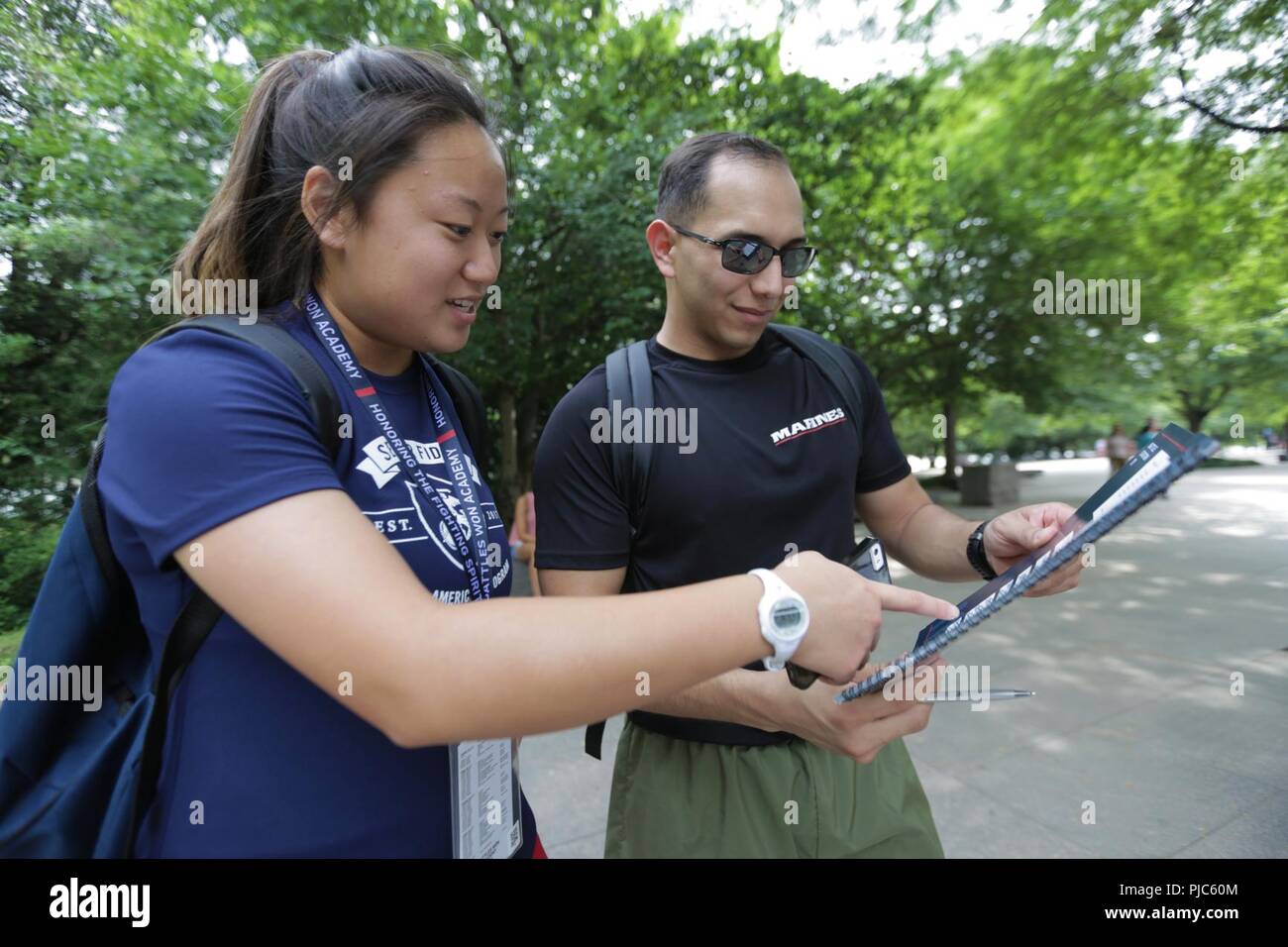 Marine Sgt. Andy Orozco and Rona Chou check their remaining objectives during the scavenger hunt at the 2018 Battles Won Academy in the District of Columbia, July 15. The Battles Won Academy is a part of the Marine Corps’ Semper Fidelis All-American Program, which recognizes young men and women who excel in athletics, but have also shown themselves to be leaders in the classroom and in their hometowns. Nearly 100 high school student-athletes attended the academy, which focused on developing their self-confidence, discipline, teamwork, and honing the fighting spirit that embodies the Marine Cor Stock Photo