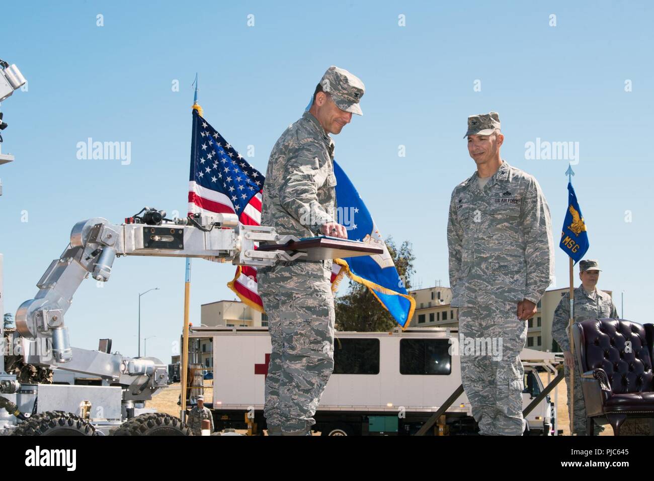 U.S. Air Force Col. Ethan Griffin, 60th Air Mobility Wing commander presents Col. Lance Clark, 60th Mission Support Group commander the Legion of Merit during the Change of Command ceremony at Travis Air Force Base, Calif., July 16, 2018. Griffin was the presiding officer for the Change of Command Ceremony. Stock Photo