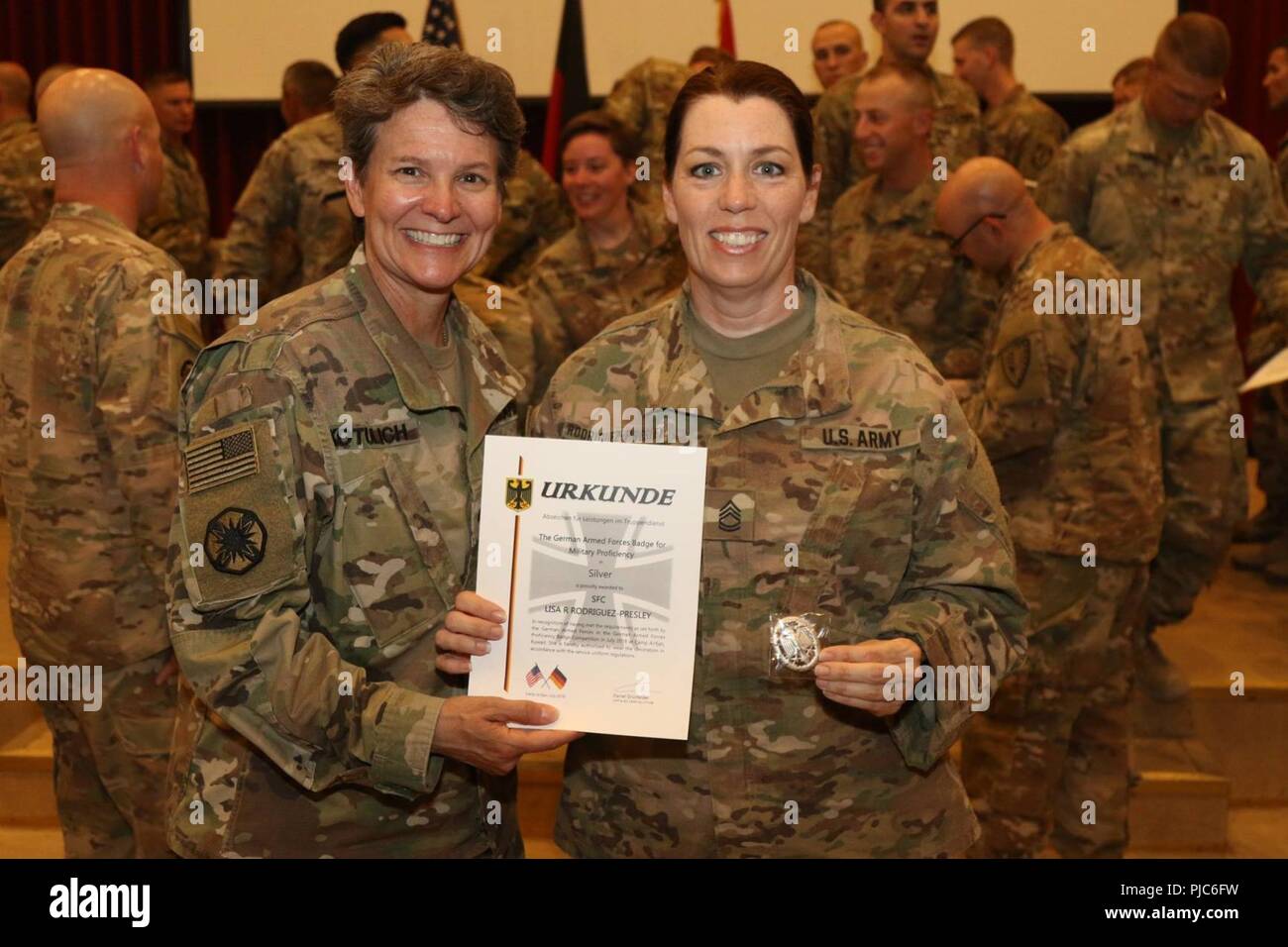 CAMP ARIFJAN, Kuwait - Sgt. 1st Class Lisa Rodriguez-Presley, of the 1st Theater Sustainment Command- Operational Command Post, stands with Brig. Gen. Deborah Kotulich, the deputy commanding general of the 1st TSC-OCP, after receiving the silver German Armed Forces Proficiency Badge, July 14.  Rodriguez-Presley was the oldest female competitor to complete the GAFPB this July.  (U. S. Army Stock Photo