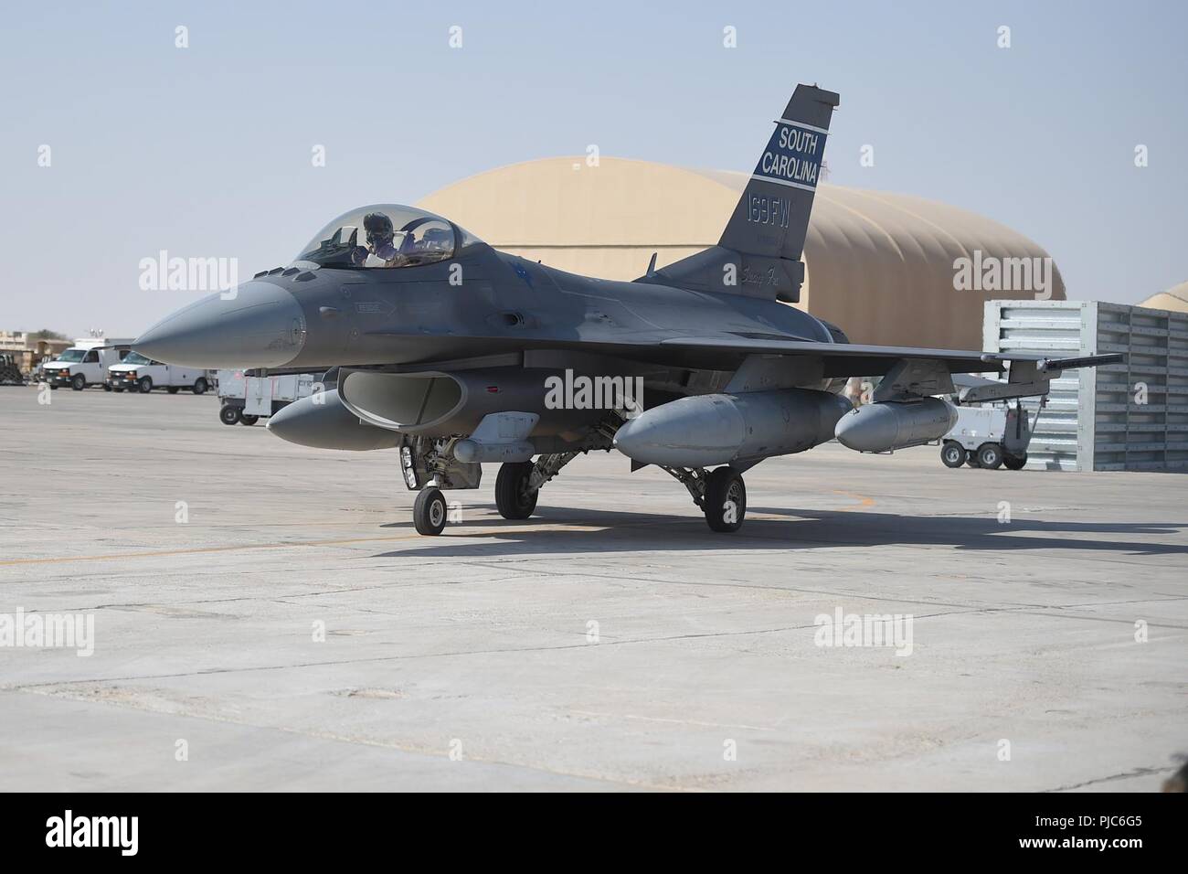 A pilot from the 157th Expeditionary Fighter Squadron prepares to park an F-16 Fighting Falcon, July 16, 2018, at an undisclosed location in Southwest Asia. More than 300 Airmen from the 169th Fighter Wing of the South Carolina Air National Guard recently deployed to the 407th Air Expeditionary Group in support of Operation Inherent Resolve. Stock Photo