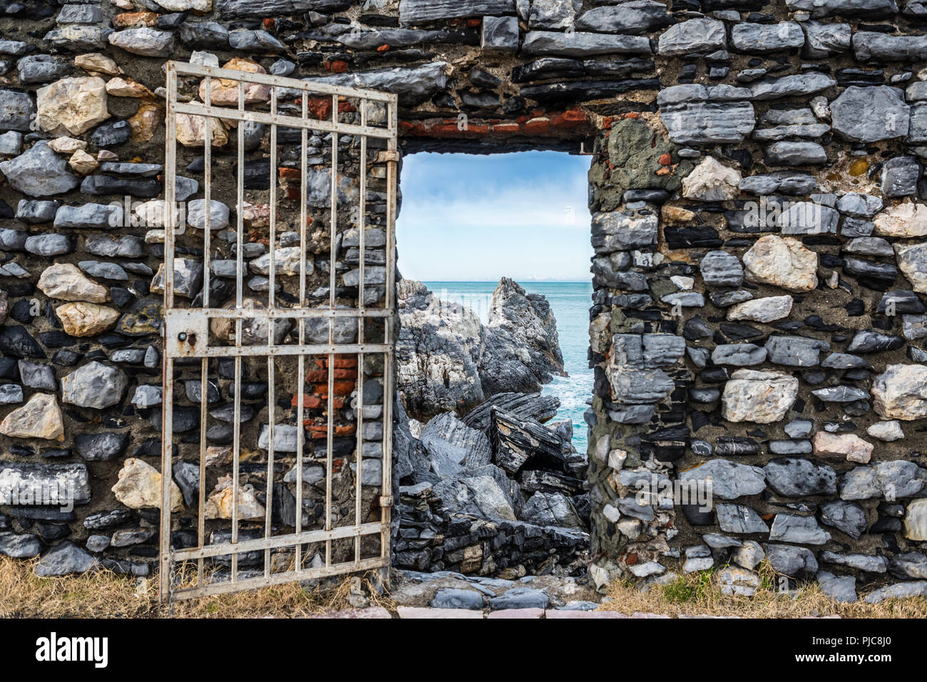 'Lord Byron's Grotto' entrance with gate on an old stone wall belonging to Castle Doria, Portovenere, La Spezia province, Liguria, Italy. Stock Photo