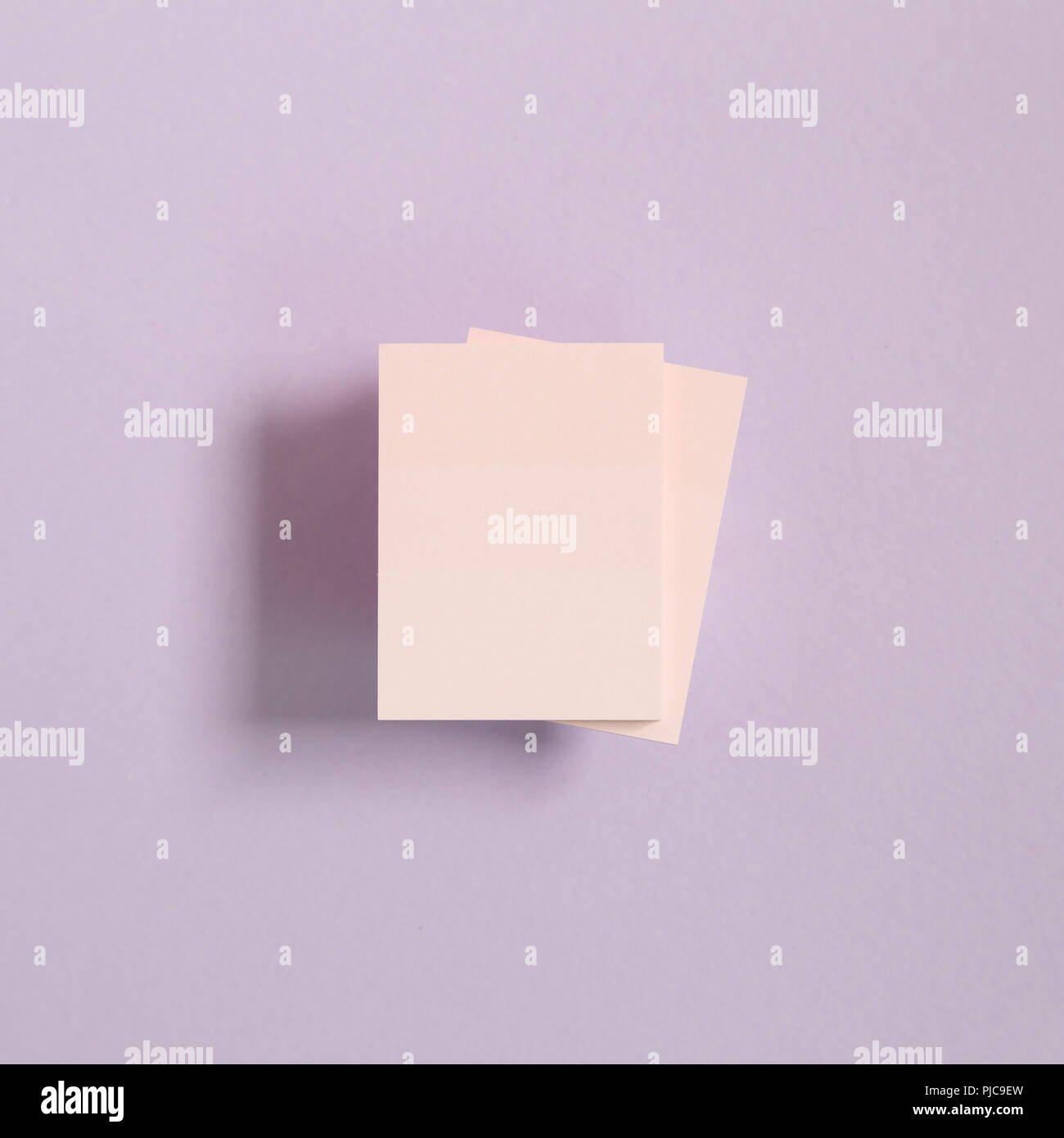 Pink memo pad, sticky notes on purple background Stock Photo