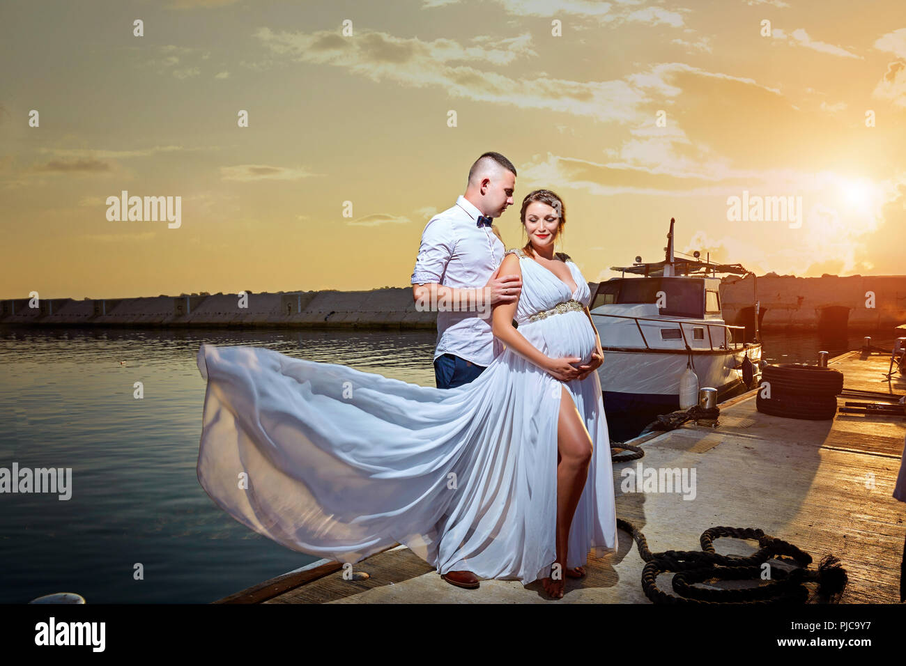Young couple in love on summer sunny evening on the sea Stock Photo