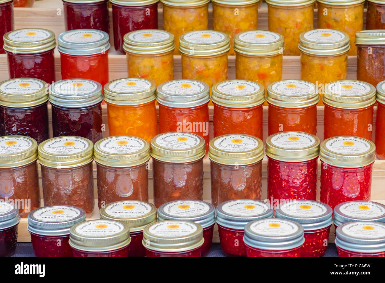 Fresh made jams and jellies on display and for sale at a local farmers market. Stock Photo