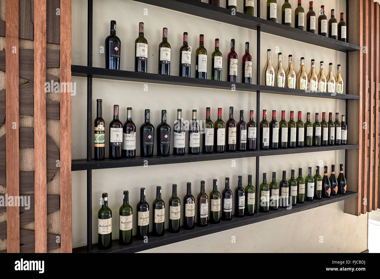 Wine rack and large selection of wines Stock Photo