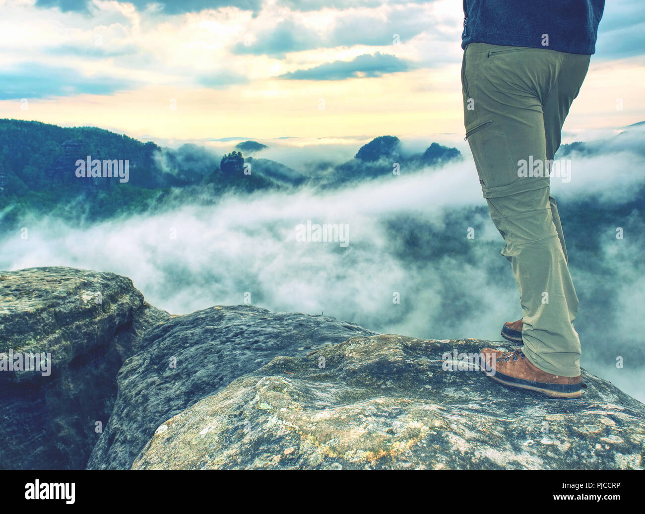 Trekking shoe and legs on rocky hiking trail in mountains motivation inspiration concept. Outdoors achievement, fitness adventure and exercising in wi Stock Photo