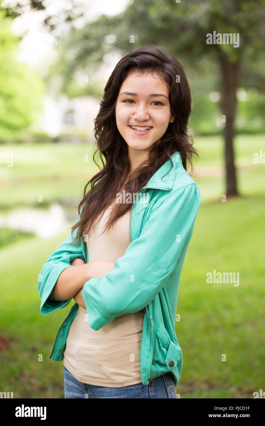 Young teen girl smiling outside. Stock Photo