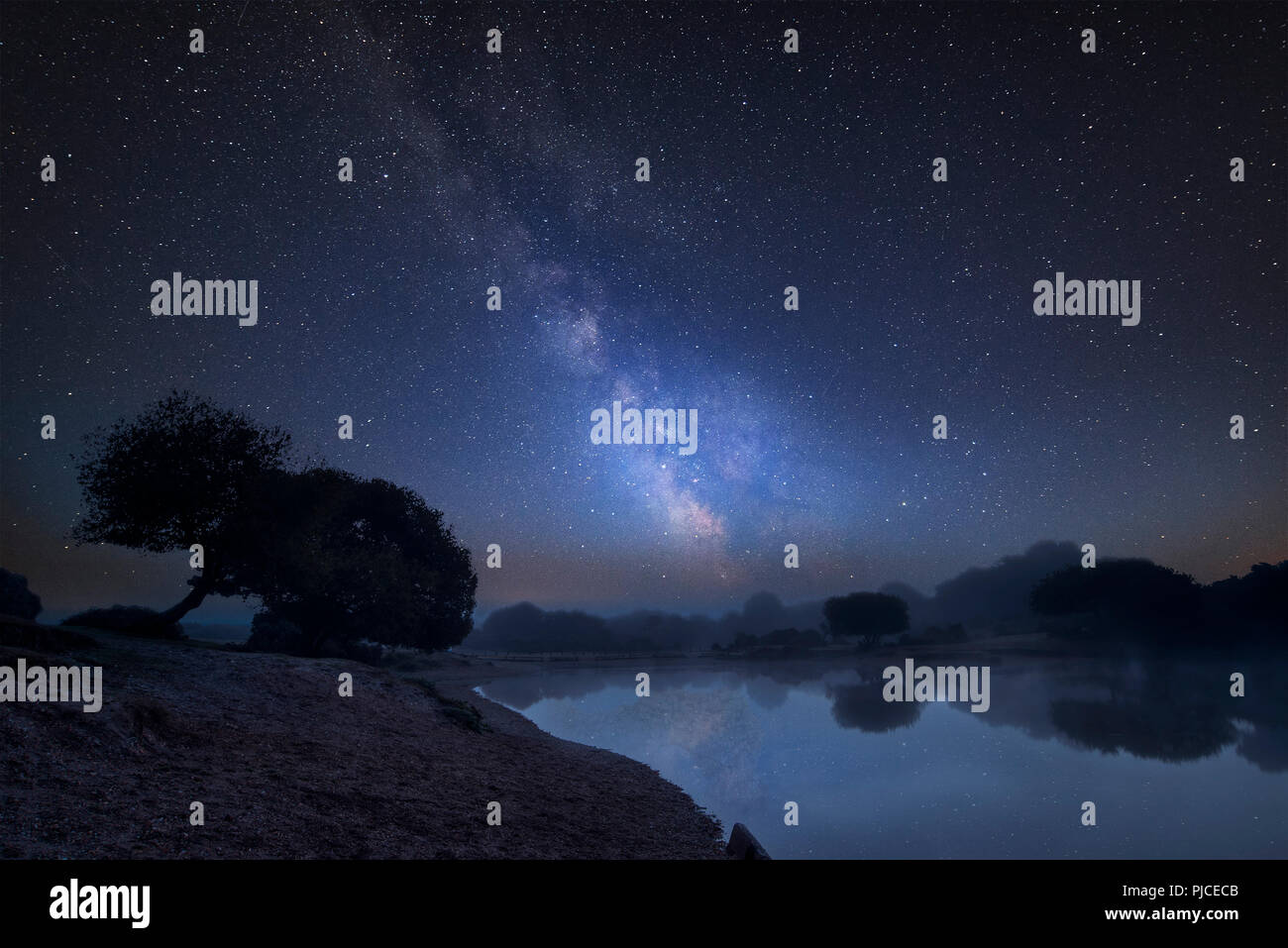 Stunning vibrant Milky Way composite image over landscape of misty lake ...