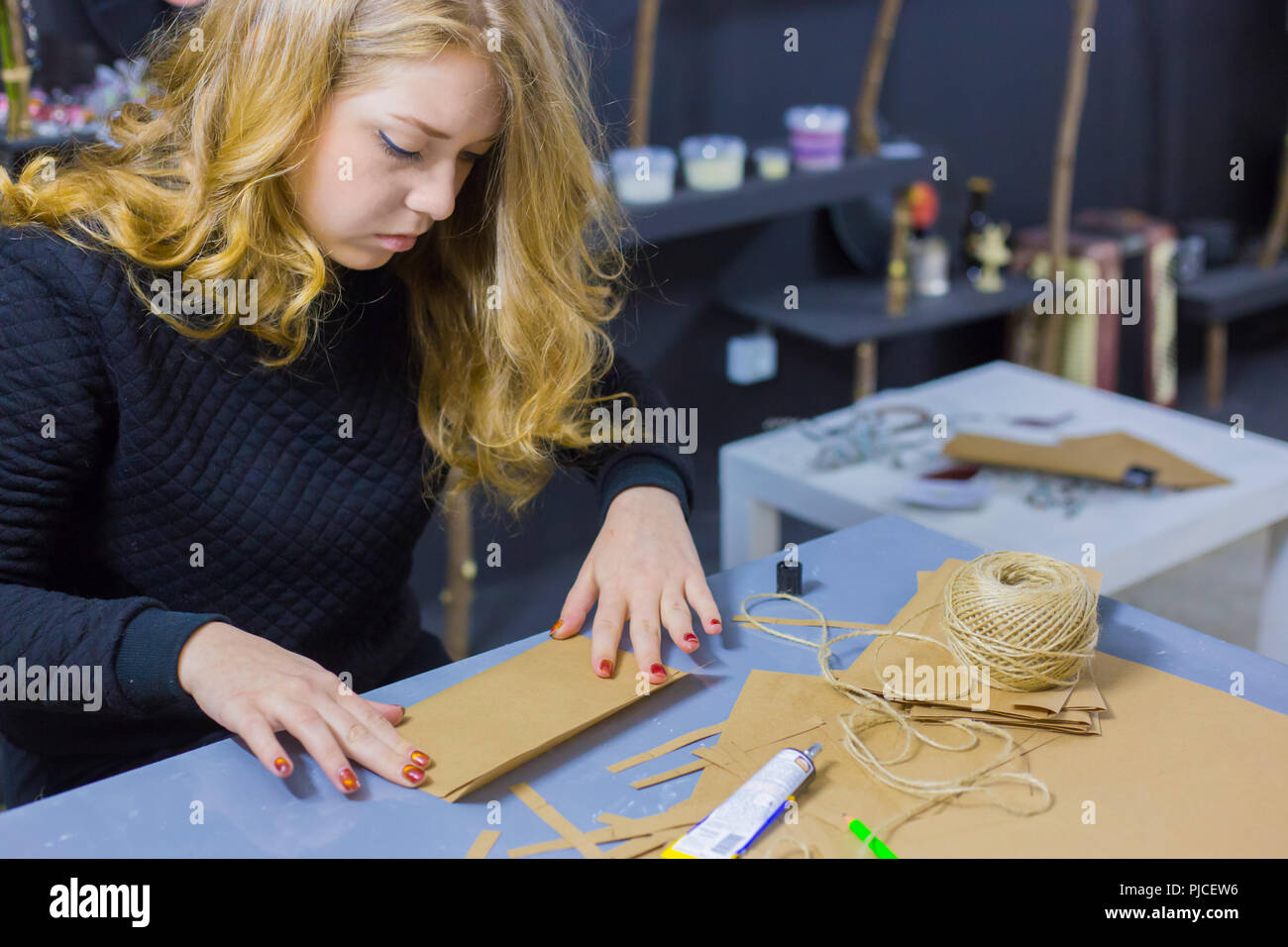 Professional woman decorator working with kraft paper Stock Photo