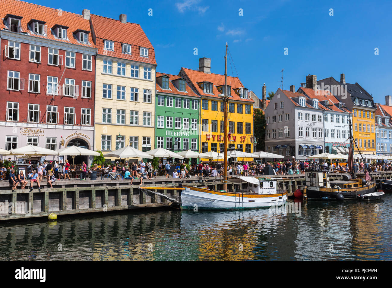 Nyhavn (New Harbour) is a 17th-century waterfront, canal and entertainment district in Copenhagen, Denmark. Stock Photo