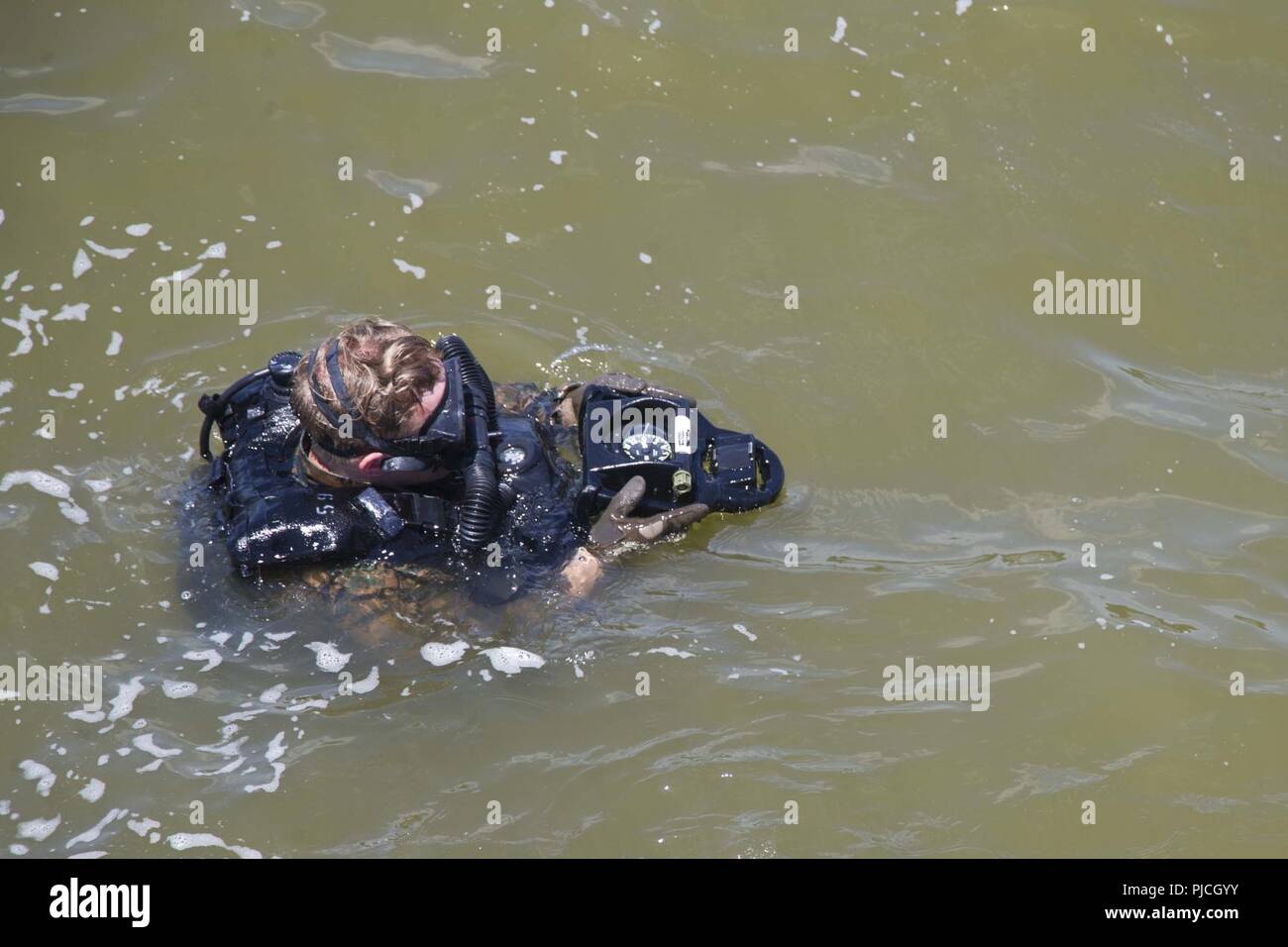 A Recon Marine with the Maritime Raid Force, 22nd Marine Expeditionary Unit gets a heading prior to sub surfacing during a Visit, Board, Search and Seizure course at Fort Eustis, VA, July 18, 2018. This course gives the MRF the capability of launching VBSS operations during the 22nd MEU’s upcoming deployment. Stock Photo