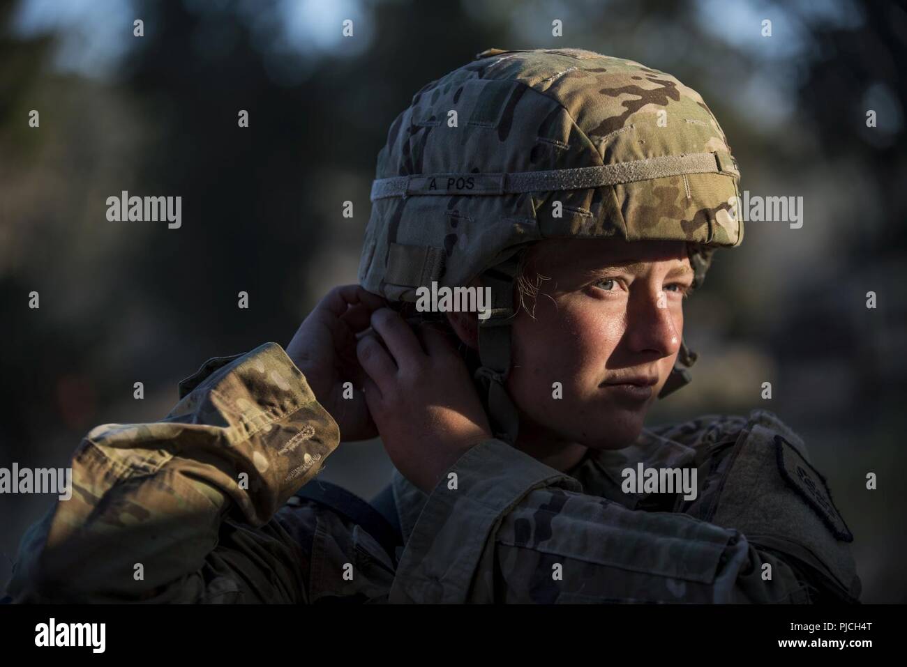 Sgt. Brooke Prigg, a U.S. Army Reserve satellite operator and maintainer with Alpha Company, 98th Expeditionary Signal Battalion, headquartered in Denver, Colorado, adjusts her helmet while training at a Combat Support Training Exercise (CSTX) at Fort Hunter Liggett, California, July 20, 2018. The signal company supported the 11th Military Police Brigade during the exercise, in which military police are responsible for a Theater Detention Facility to processes and secure up to 4,000 enemy prisoners of war and also manage a Detention Holding Area to house displaced civilians. Military police ha Stock Photo