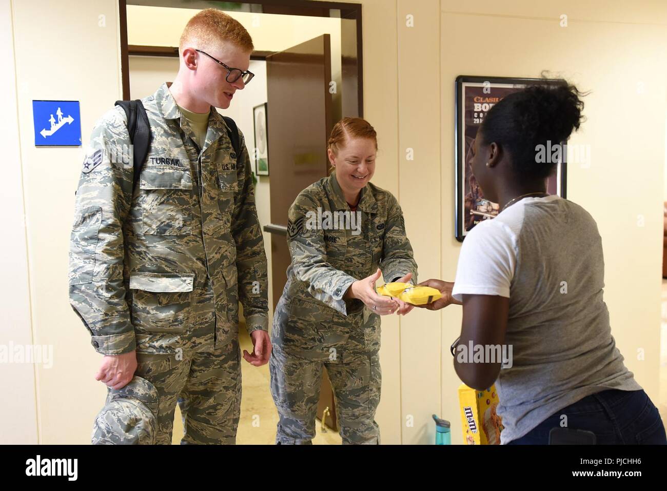 U.S. Air Force Airman 1st Class Valtrice Sullivan, 39th Security Forces Squadron contingency deployer and USO volunteer, hands out ice cream to Airmen at Incirlik Air Base, Turkey, July 13, 2018. Frozen Friday is one of the reoccurring programs hosted by the USO to raise the moral of service members on bae. Stock Photo
