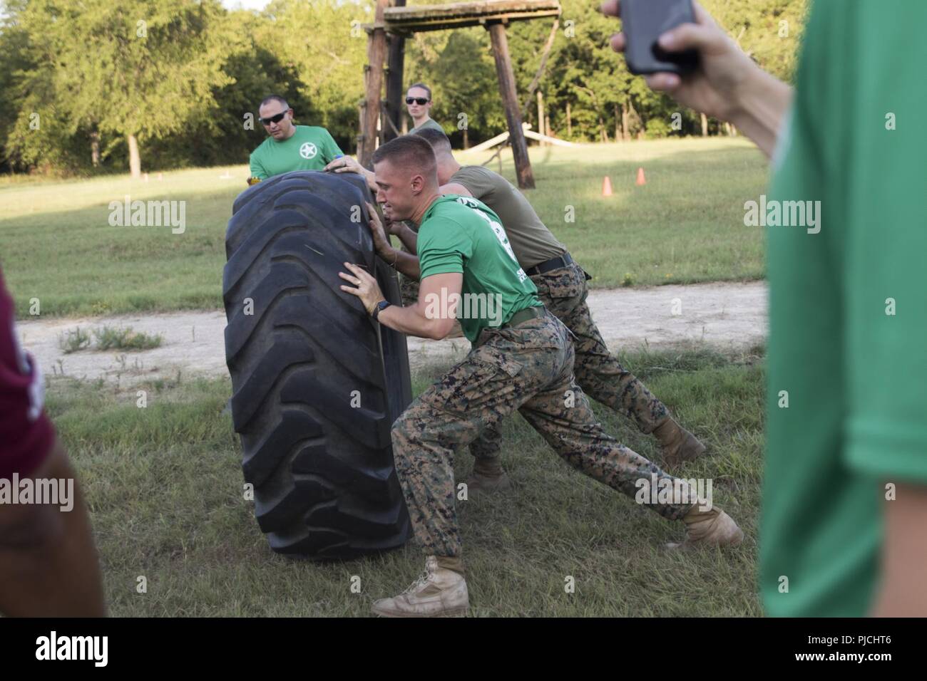 Marines do a series of tire flips in a timed event at Camp Maxey