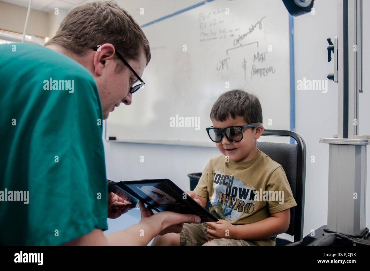 Jonathan Howard, a local resident, receives an eye exam from Maj. Matthew Simpson, an