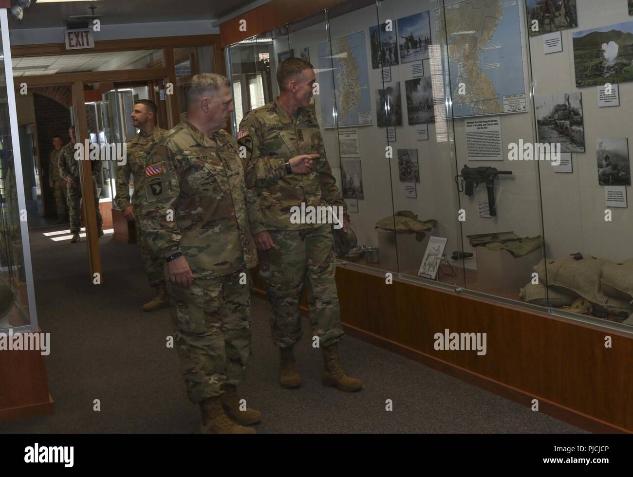 Chief of Staff of the Army Gen. Mark A. Milley and America’s First Corps Commanding General Lt. Gen. Gary Volesky talk about the photos of past Corps leaders lining the hallway at the I Corps headquarters on Joint Base Lewis-McChord, Washington, July 23, 2018. Milley visited JBLM to meet with Soldiers and leaders from I Corps, 7th Infantry Division, 1st Special Forces Group and 2nd Battalion, 75th Ranger Regiment. Milley discussed Soldier and Family readiness and the future of the force. Americas First Corps is celebrating its “100 Years of Courage” centennial throughout 2018.  U.S. Army Stock Photo