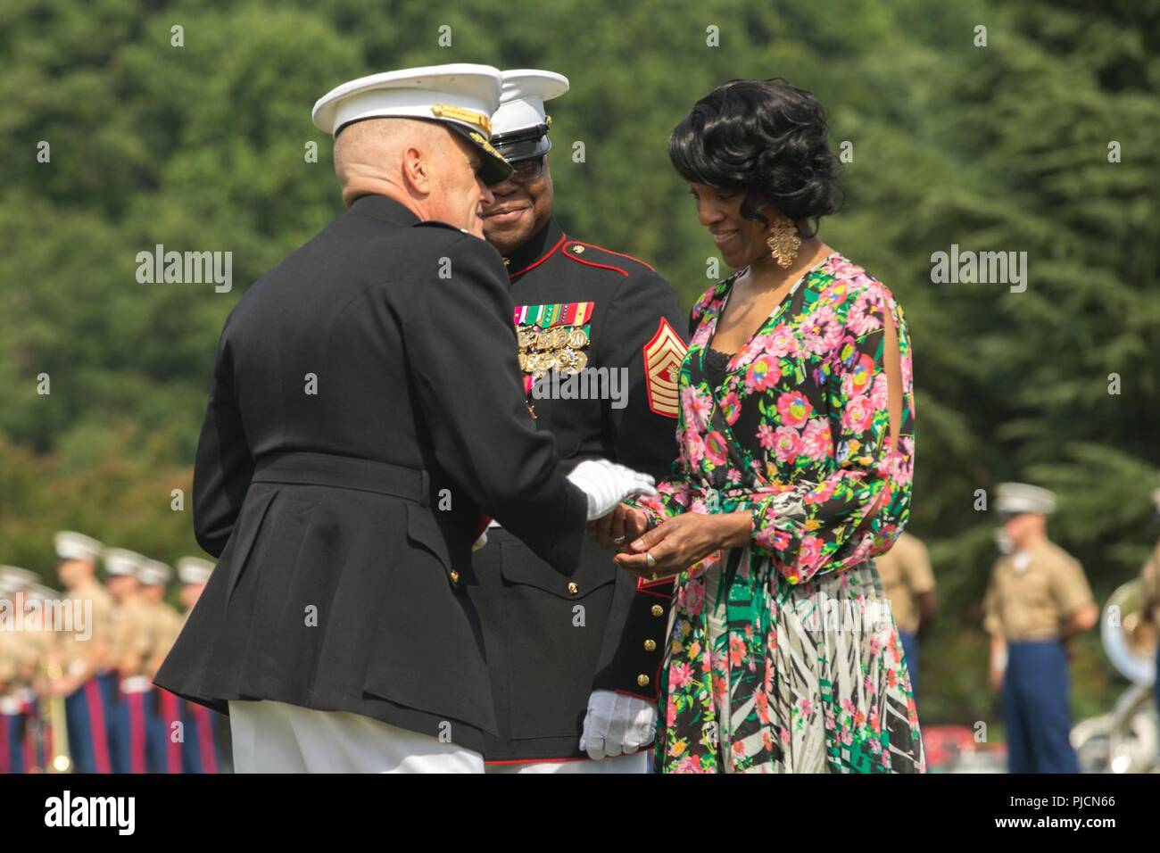 U.S. Marine Maj. Gen Vincent Coglianese, commander, Marine Corps Installations Command, Presents a coin and certificate of appreciation to Venessa Mayhues, wife of Master Gunnery Sgt. Andre Mayhue, transportation branch chief, HQ&SVC BN, on Lejeune Feild, Marine Corps Base Quantico, Va., July 20, 2018. Mayhue served 30 years of honorable and faithful military service. Stock Photo