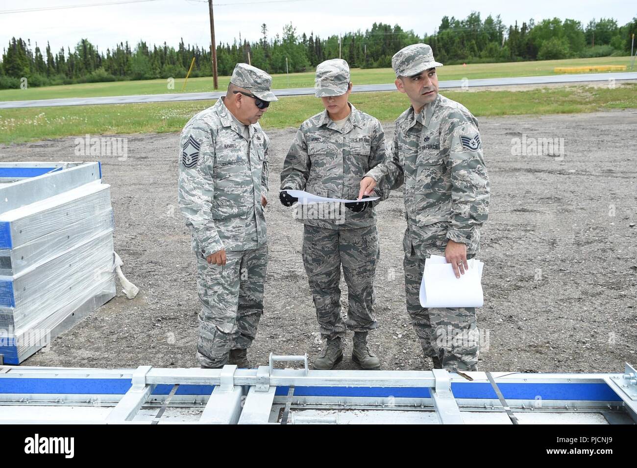Left to right, Chief Master Sgt. Frank Ramirez, the chief enlisted manager  of the 149th Civil Engineer Squadron, headquartered at Joint Base San  Antonio-Lackland, Texas, consults construction plans with Senior Master Sgt.