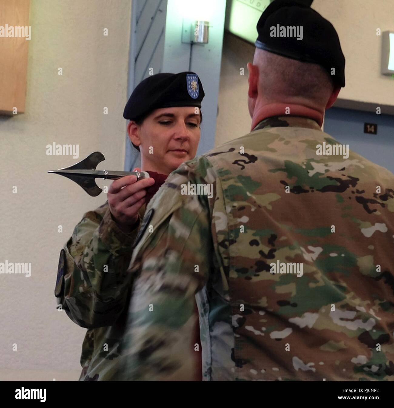 As a symbol of completion of a transition of authority over the Deployed Warrior Medical Management Center, 7221st Medical Support Unit Commanding Officer, Lt. Col. Katherine Marr, unfurls the unit guidon during a ceremony conducted at the Landstuhl Regional Medical Center Chapel, Landstuhl, Germany on July 12, 2018.  The 7221st assumes command of the DWMMC from the 7217th MSU, and will be on station in Germany for one year. Stock Photo