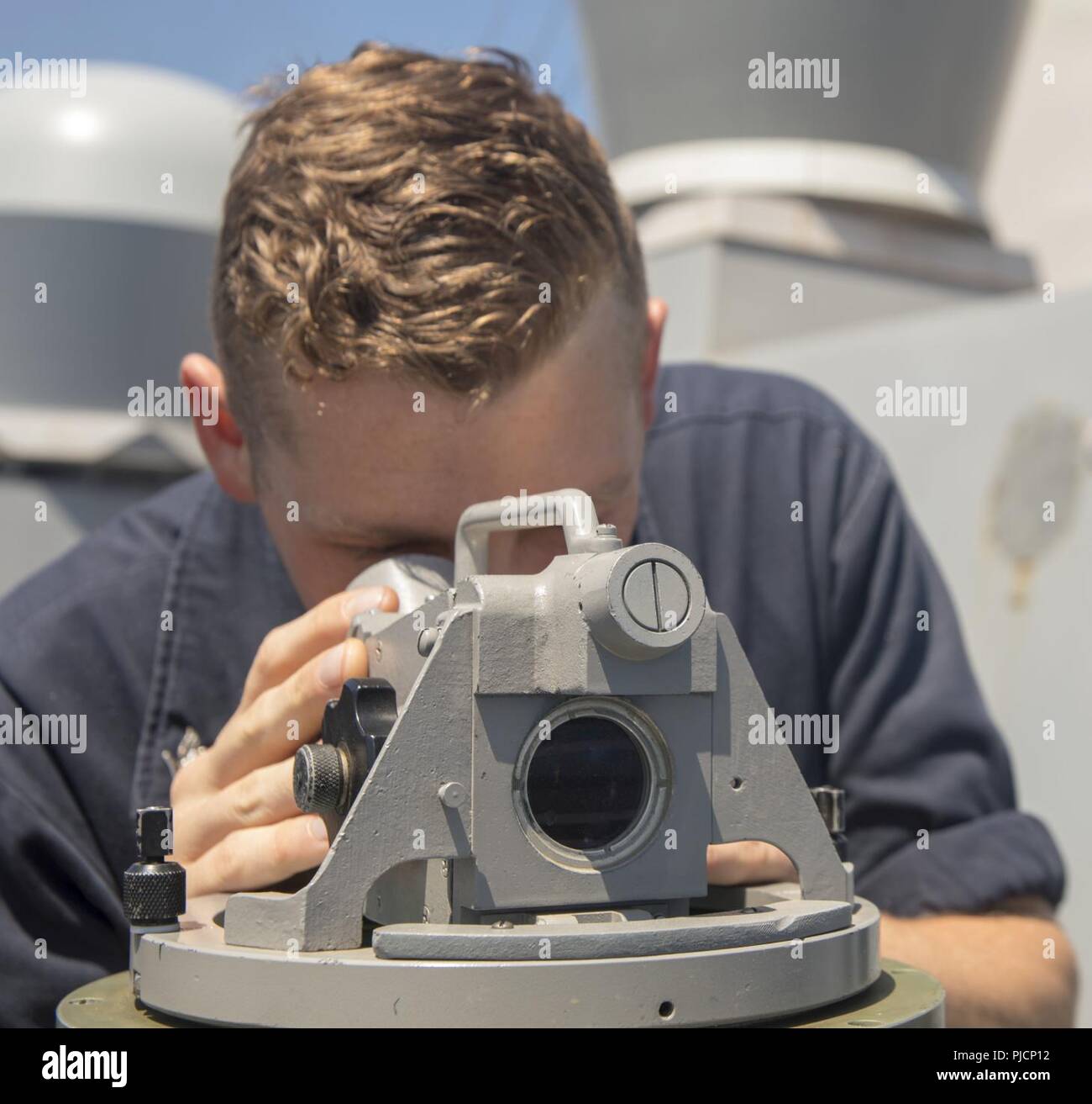 MEDITERRANEAN SEA (July 20, 2018) Quartermaster 3rd Class Gregory Morgan, from Denver, looks through the telescopic alidade on the bridge wing of the San Antonio-class amphibious transport dock ship USS New York (LPD 21) July 20, 2018. New York, homeported in Mayport, Florida, is conducting naval operations in the U.S. 6th Fleet area of operations in support of U.S. national security interests in Europe and Africa. Stock Photo