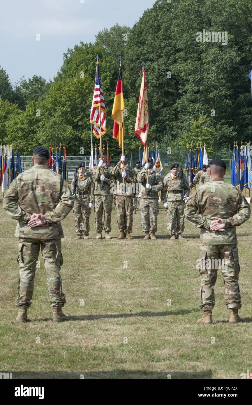 Ansbach, Germany -- Outgoing U.S. Army Garrison (USAG) Ansbach commander Col. Benjamin C. Jones (left), relinquishes command to incoming commander Col. Steven M. Pierce (right) during the USAG Ansbach Change of Command ceremony at Barton Barracks, Ansbach, Germany, July 18, 2018. Stock Photo