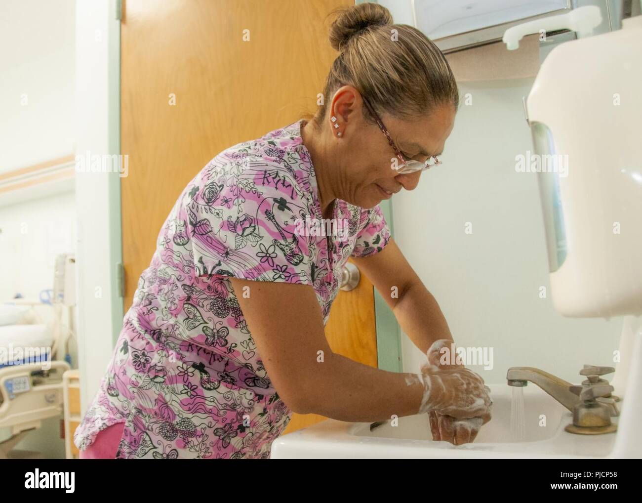 Genevieve MacFall, certified nurse assistant, Surgical Ward, William Beaumont Army Medical Center, washes her hands as part of routine hand hygiene practice at WBAMC, July 24. WBAMC led other Military Treatment Facilities of its size in the U.S. Army Medical Command (MEDCOM) in patient perception of healthcare providers practicing hand hygiene during inpatient treatment for the second quarter of fiscal year 2018, according to TRICARE Inpatient Satisfaction Surveys (TRISS). Stock Photo