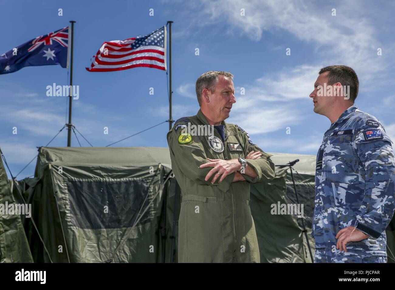 JOINT BASE PEARL HARBOR-HICKAM, Hawaii (July 21,2018) Combined Task Group Commander, Wing Commander Peter Gibson, from the Royal New Zealand Air Force (left) and Combined Task Group Battle Watch Captain, Flight Lieutenant David Reid, from the Royal Australian Air Force, outside the combined watch floor and mobile tactical operations center during Rim of the Pacific (RIMPAC) exercise, July 21. Twenty-five nations, 46 ships, five submarines, and about 200 aircraft and 25,000 personnel are participating in RIMPAC from June 27 to Aug. 2 in and around the Hawaiian Islands and Southern California. T Stock Photo