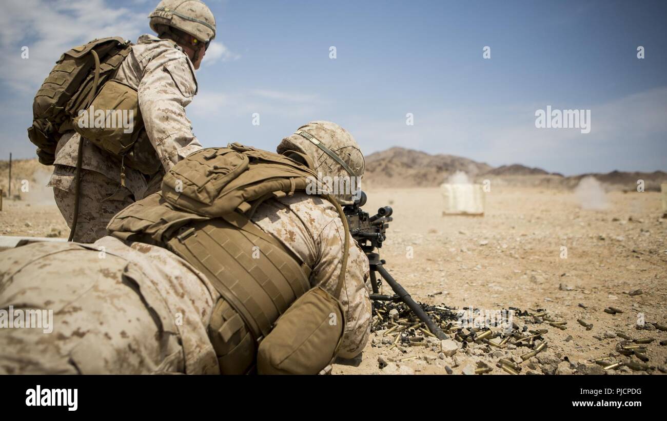 U.S. Marines and Sailors with 3rd Battalion, 6th Marine Regiment fire an M-240 B machine gun during a battle sight zero (BZO) range at Marine Corps Air Ground Combat Center Twentynine Palms, CA, on July 15, 2018. The purpose of this range is to ensure the accuracy of the machine guns in preparation for Integrated Training Exercise (ITX) 5-18. Stock Photo