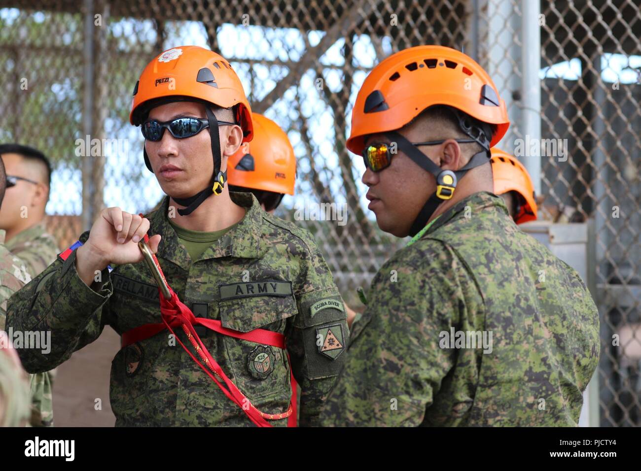 Soldiers of the Philippines Army 525th Engineer Combat Battalion take part in harness tying exercises during a confined space rescue class in Kapolei, Hawaii, July 9,2018. This marks the first joint training exercise between the HIARNG, Philippine, and Indonesian, Chemical, Biological, Radiological, Nuclear and High-Yield Explosive, Enhanced Response Force Package teams. Stock Photo
