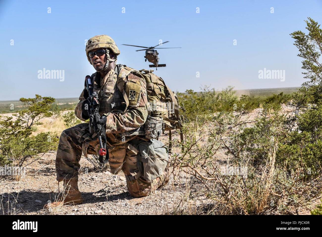 After the nine line MEDEVAC was called up, Spc. Tristian McFadden, a petroleum supply specialist from 11th ADA, 1-43 Battalion, Charlie Battery, waited for air support during the rescues mission at Wagali Village July 18, 2018. (By Sgt. La’Shawna Custom, 32d AAMDC Public Affairs NCO) Stock Photo