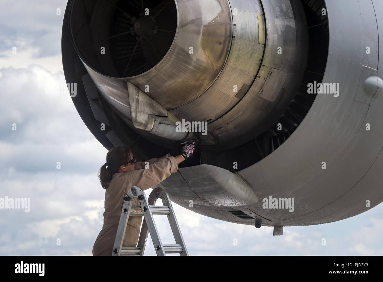 Master Sgt. Angelia Gholson, 164th Aircraft Maintenance Squadron flying crew chief, Memphis Air National Guard Base, TN, inspects the engine of a C-17 Globemaster III, July 5, 2018, at Moody Air Force Base, Ga. Airmen loaded approximately 68,000 pounds of cargo onto a C-17 Globemaster III to aid the 75th Fighter Squadron (FS) prior to a deployment. The 75th FS and supporting units recently deployed to an undisclosed location in support of Operation Spartan Shield. Stock Photo