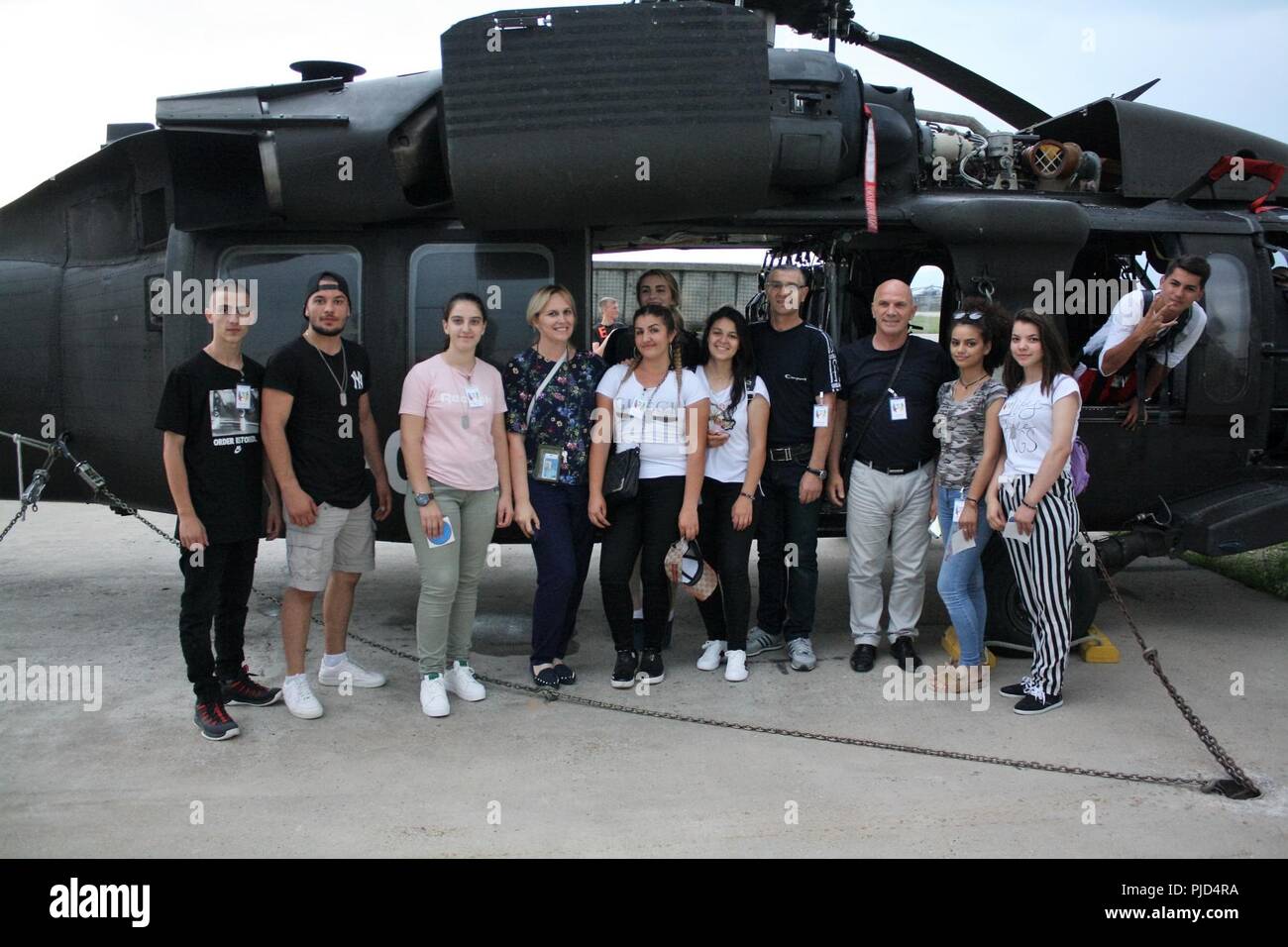 Kosovo youth and their chaperones check out a Multi-National Battle Group - East UH-60 Black Hawk helicopter during a visit to the camp on June 15. Stock Photo
