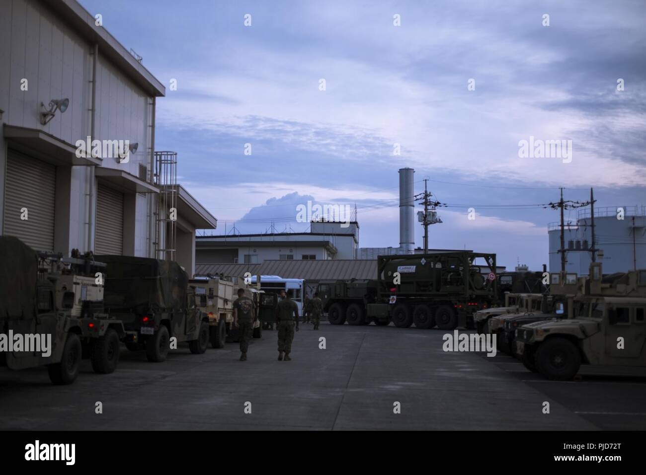 U.S. Marines with Marine Wing Support Squadron (MWSS) 171 inspect tactical vehicles before a convoy at Marine Corps Air Station Iwakuni, Japan, July 13, 2018. The convoy took service members with MWSS-171 to Combined Arms Training Center (CATC) Camp Fuji in order to begin exercise Eagle Wrath 18, an annual training exercise assessing the squadron’s combat readiness. Stock Photo