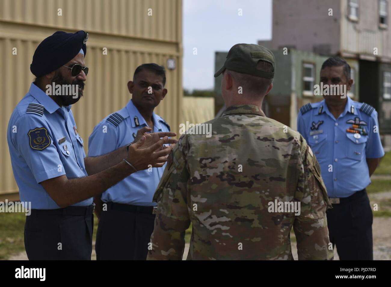 U.S. Air Force Captain Samuel Doyel, 736th Security Forces Squadron commando warrior officer in-charge, speaks with India Air Force Subject Matter Experts during a Security Forces SMEE July 23, 2018, on Andersen Air Force Base, Guam. Stock Photo