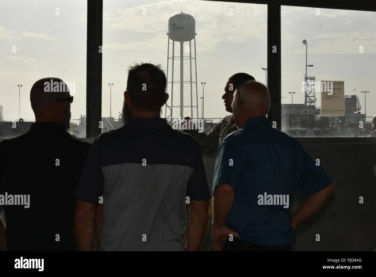 Clayton Garland, Nathan Garland and Louis Garland, decedents of late Chief Warrant Officer Louis F. Garland, speak with U.S. Air Force Master Sgt. Roy Campos, 312th Training Squadron advance courses chief, in the Louis F. Garland Department of Defense Fire Academy on Goodfellow Air Force Base, Texas, July 13, 2018. The fire academy services all aspects of the DoD; including Army, Marine Corps, Navy, Air Force, and Civil Service employees. Stock Photo