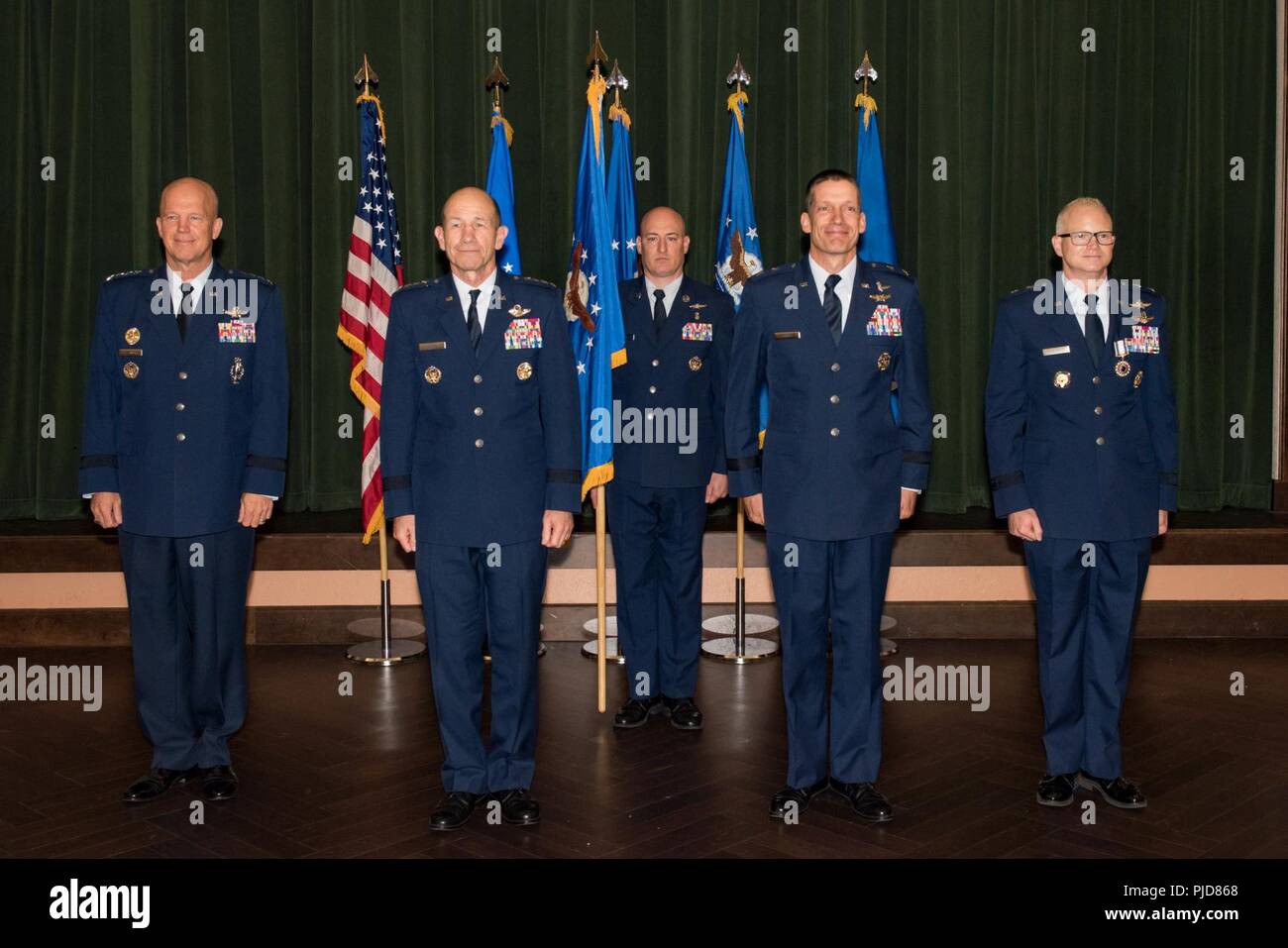 Gen. Mike Holmes, commander of Air Combat Command, officiates the change of command ceremony where  24th Air Force guidon passes to Maj. Gen. Robert Skinner upon assuming command of the 24th AF at Joint Base San Antonio-Lackland, Texas, July 17, 2018. Twenty Fourth Air Force was reassigned to a new major command and welcomed Skinner during the ceremony. Stock Photo