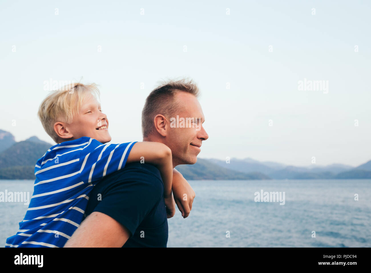 Father and son together. Son hugging father. Summer vacation. Selective focus. Stock Photo