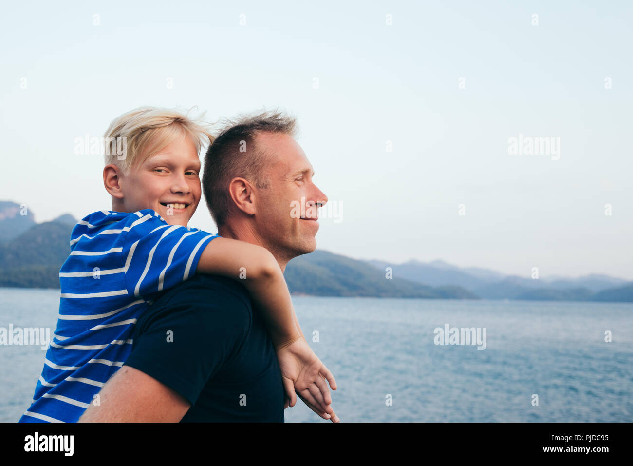 Father and son together. Son hugging father. Summer vacation. Stock Photo