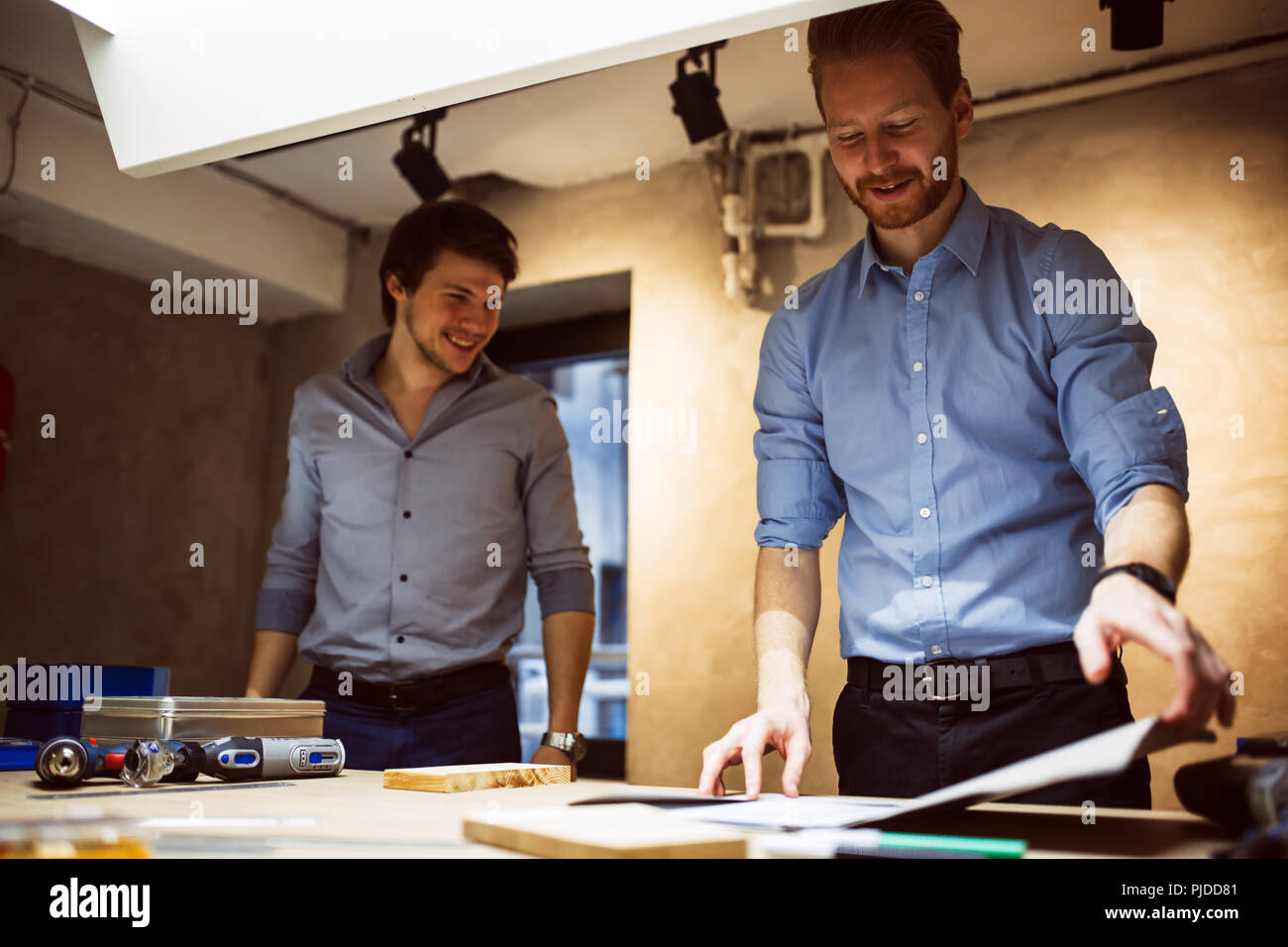 Two creative designers working in workshop Stock Photo