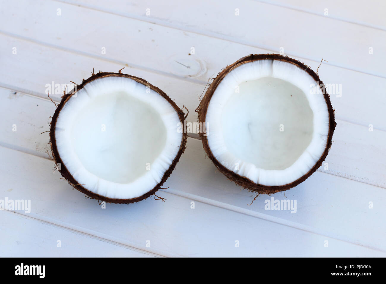 Coconut on white wooden background Stock Photo