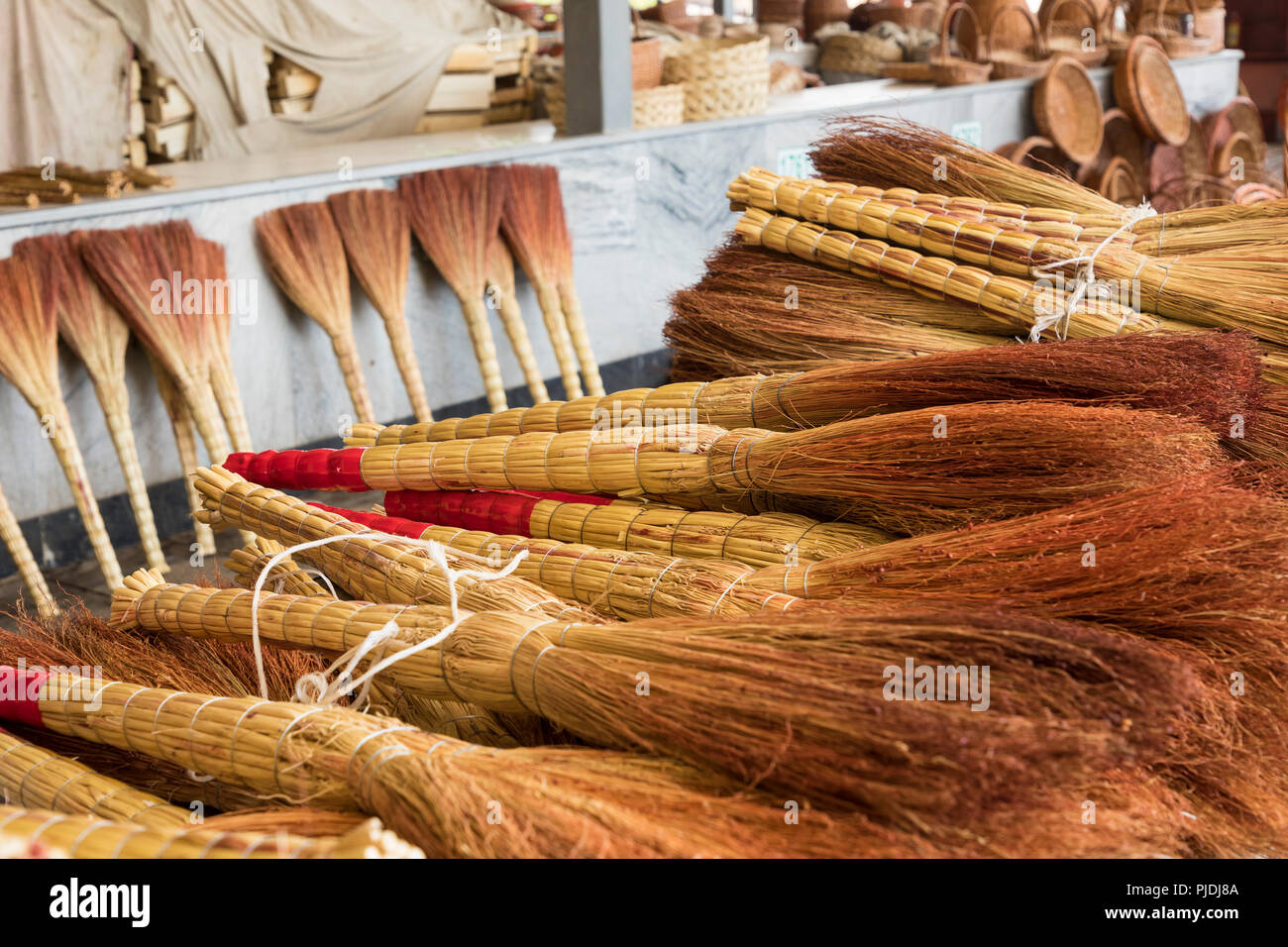 A pile of bamboo brooms in market for sale at Uzbekistan bazaar. Stock Photo